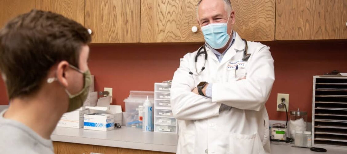 A adult patient consults with his physician during an adult routine preventative care exam brought you by Richfield Medical Group