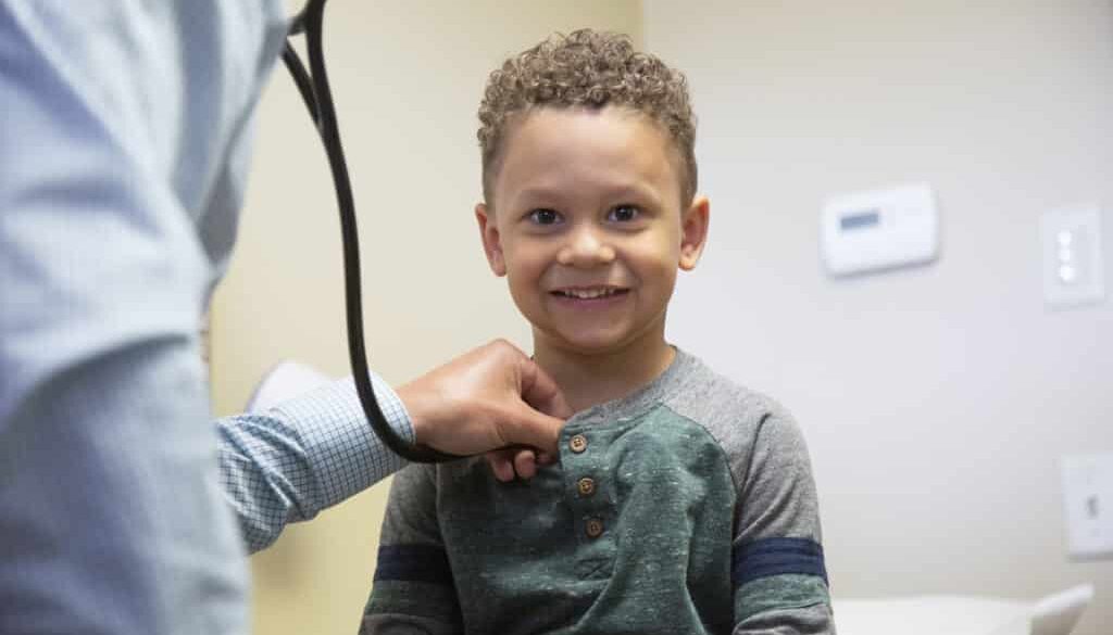 A child smile during his pediatric care appointment. Find the best pediatrician near you with Richfield Medical Group