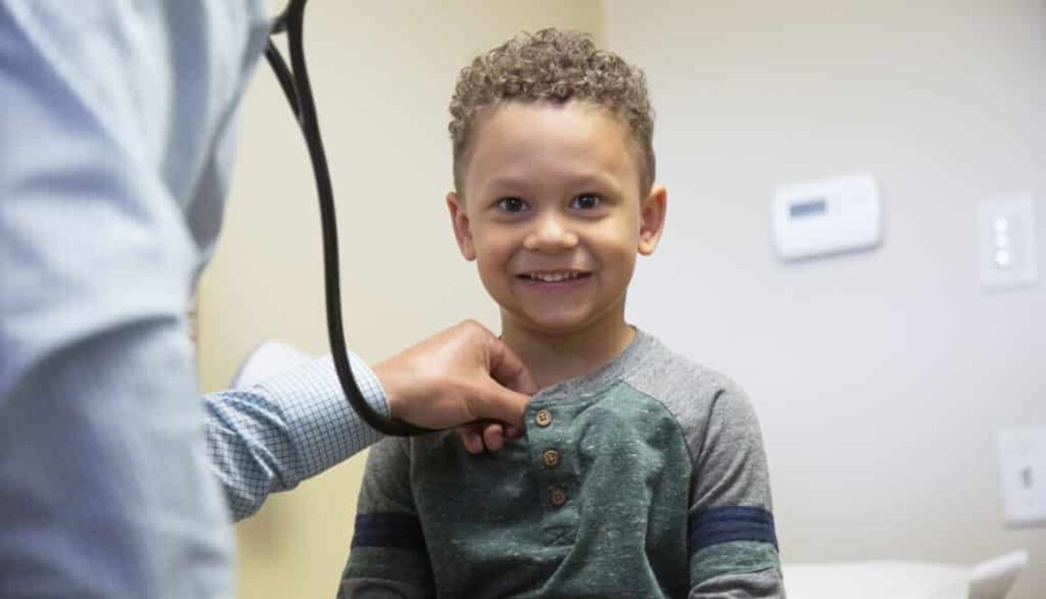 A child smile during his pediatric care appointment. Find the best pediatrician near you with Richfield Medical Group