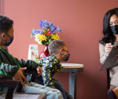A mother schedules her next clinic visit for her children in the waiting room at Richfield Medical Group in Minnesota.