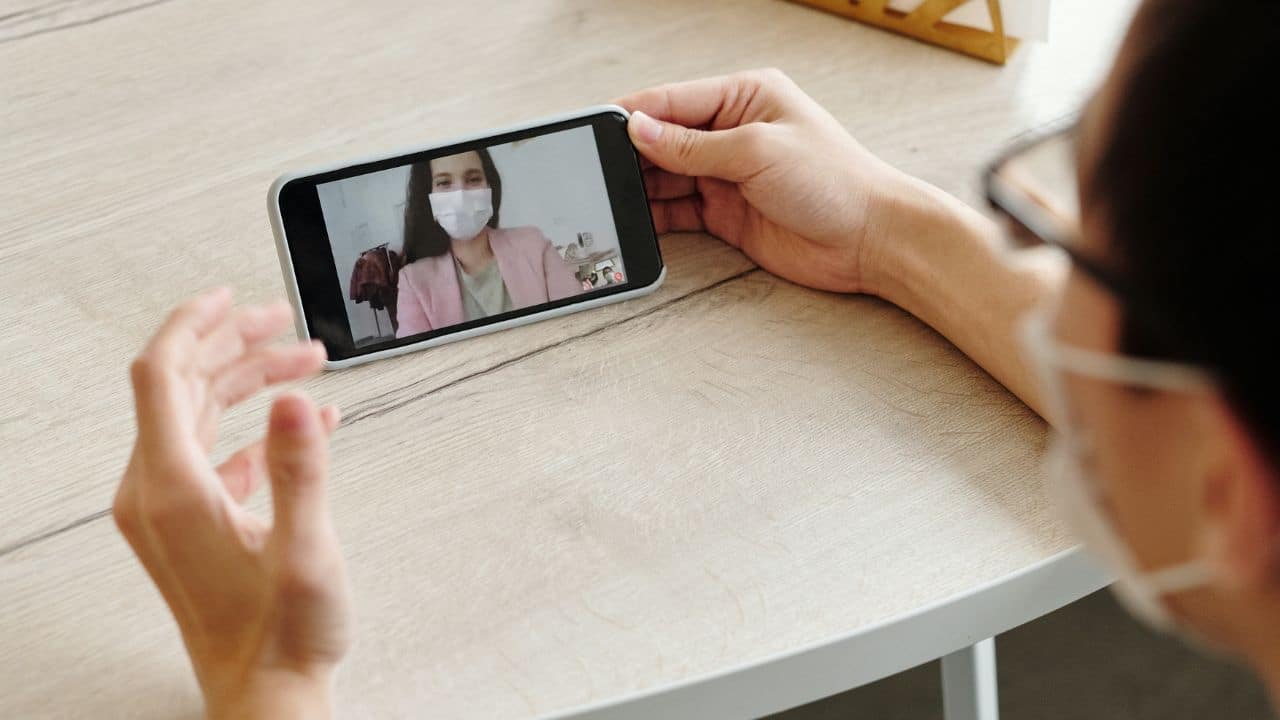 A patient meets with their doctor over a video chat. 