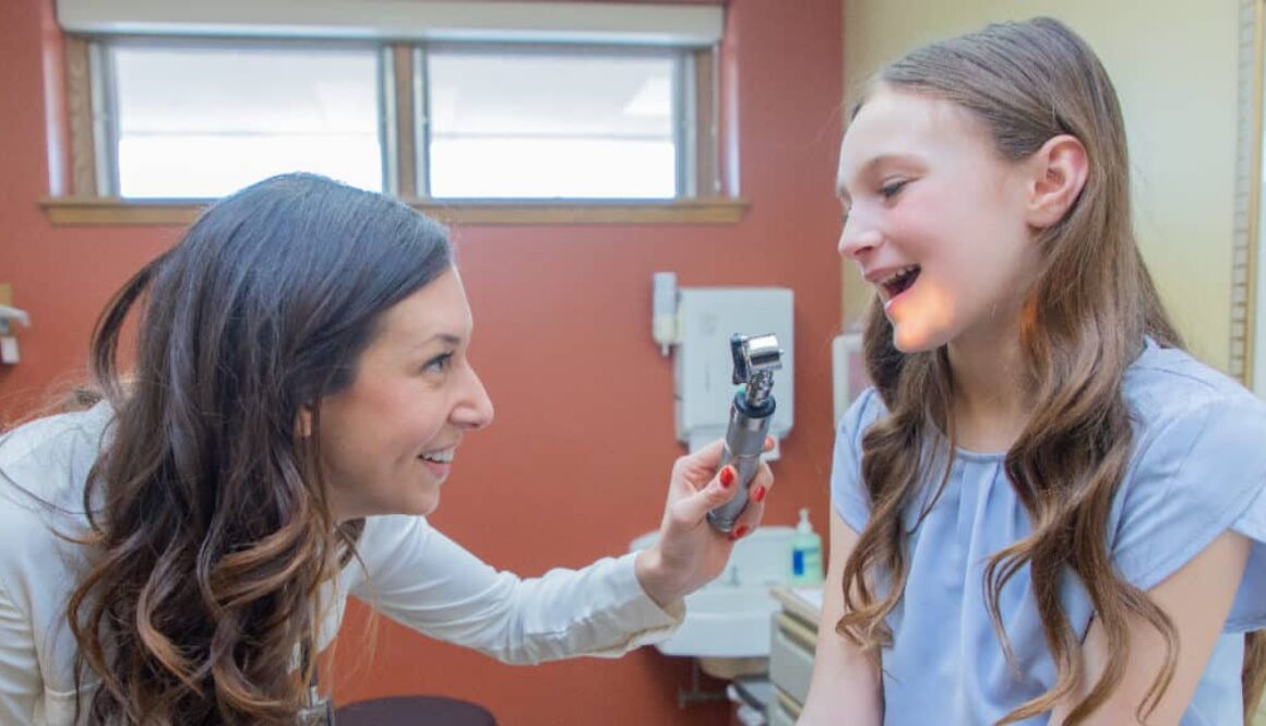 A doctor at Richfield Medical Group inspects a smiling child during a pediatric visit