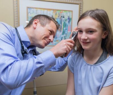 Doctor looking in a child's ear.